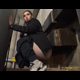 Miss Marilyn squats with her pants down under concrete stairs. No pooping shown. Widescreen format video. Over a minute.